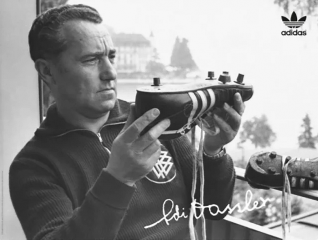 adi dassler, showcing the first adi dassler football boot of 1954